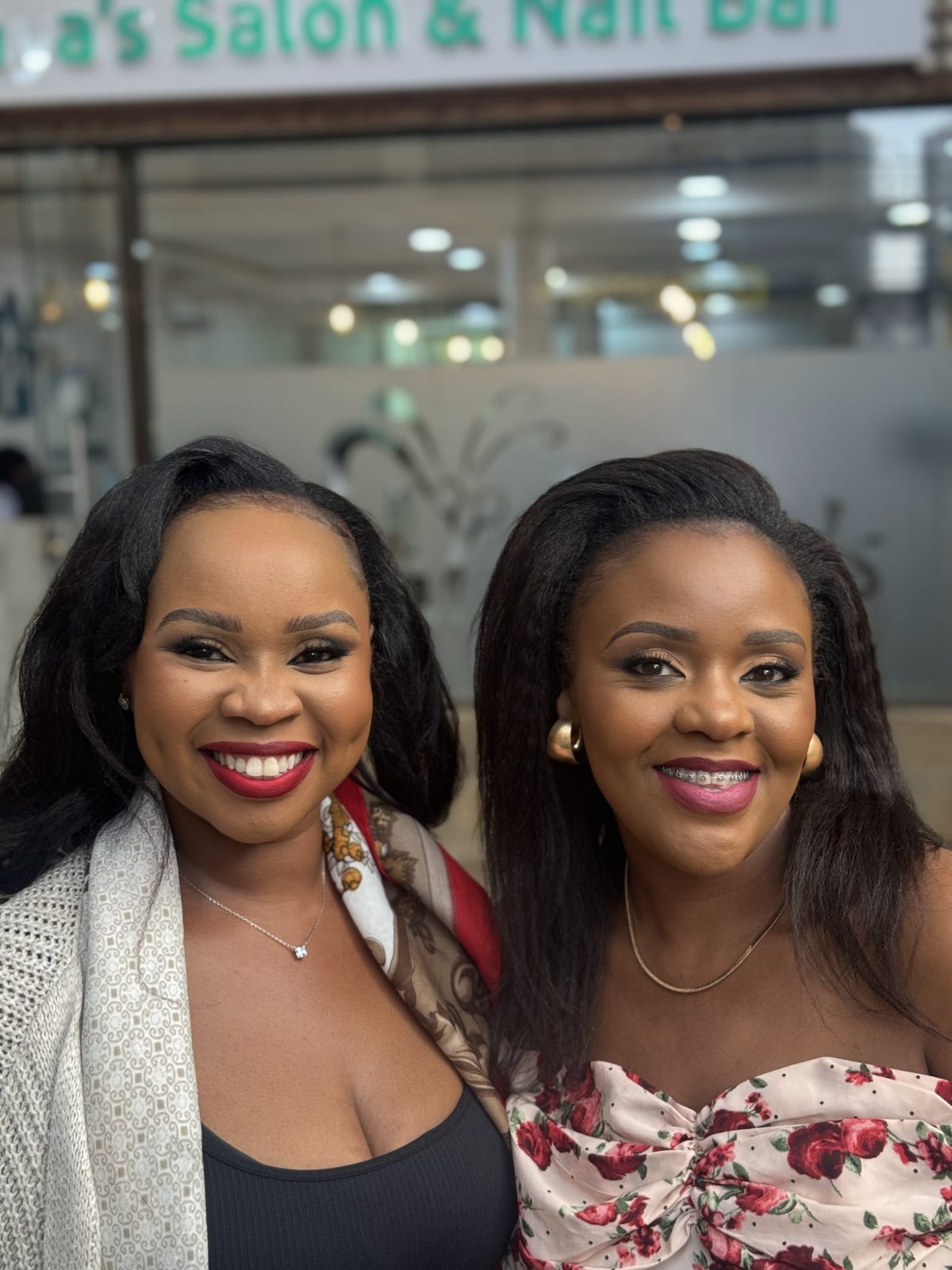 Two happy clients smiling together inside Maya's Salon on Ngong Road, Nairobi